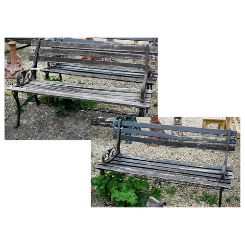 82 - A pair of teak slat garden benches with cast ends. each 122 cm long and a/f (2)