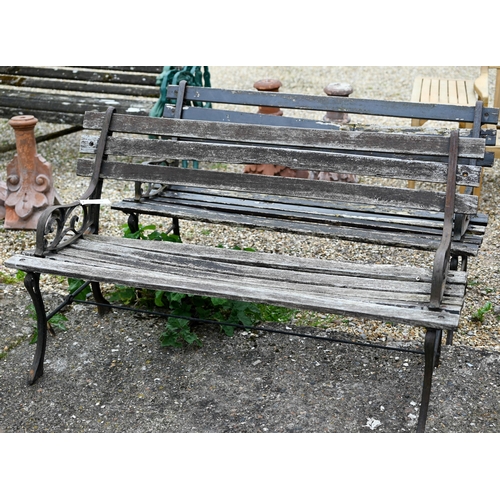 82 - A pair of teak slat garden benches with cast ends. each 122 cm long and a/f (2)