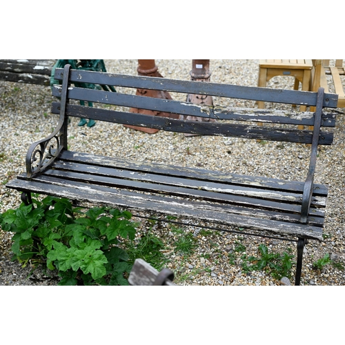 82 - A pair of teak slat garden benches with cast ends. each 122 cm long and a/f (2)