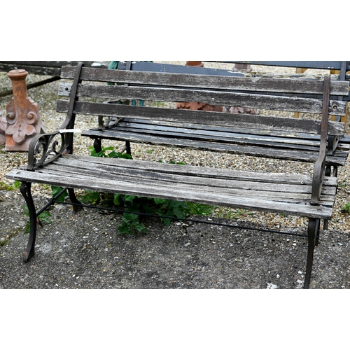 82 - A pair of teak slat garden benches with cast ends. each 122 cm long and a/f (2)