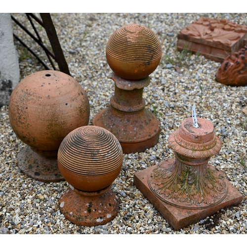 85 - Various assorted terracotta items, including a pair of ribbed ribbed spheres, a cast tulip vase urn ... 