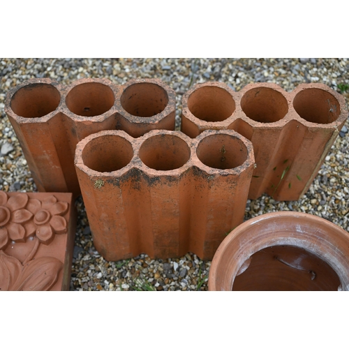 86 - A trio of hexagonal terracotta triple bricks to/with a pair of decorative Arts & Crafts style wa... 