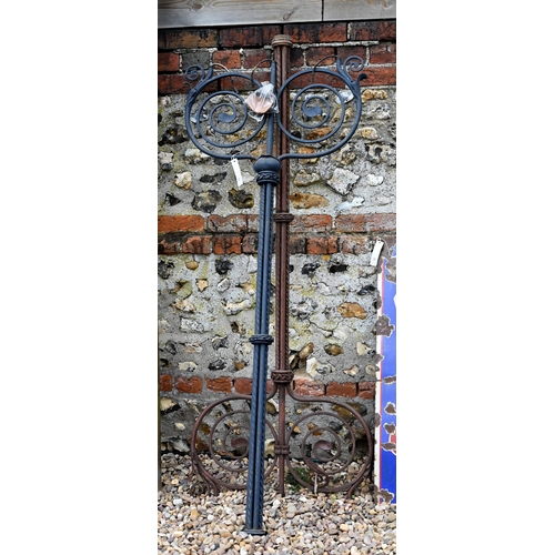 93 - Two differing ornate wrought iron garden lighting frames/stands with butterflied spiral finials - bo... 