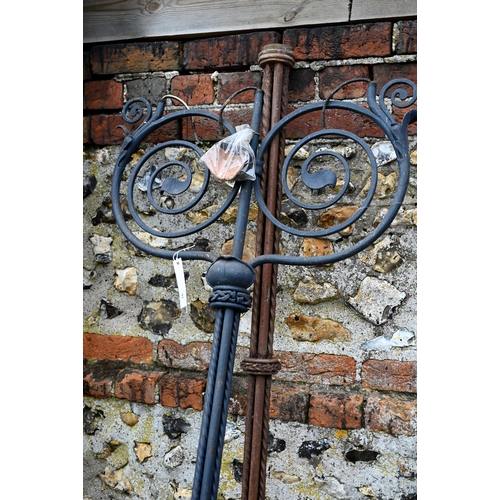 93 - Two differing ornate wrought iron garden lighting frames/stands with butterflied spiral finials - bo... 