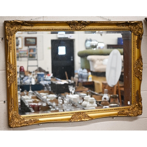 240 - A bevelled rectangular wall mirror in decorative giltwood and gesso frame, 104 x 78 cm a/f