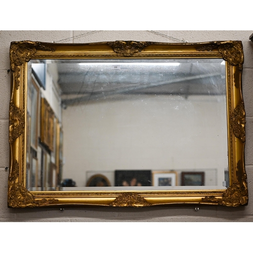 240 - A bevelled rectangular wall mirror in decorative giltwood and gesso frame, 104 x 78 cm a/f