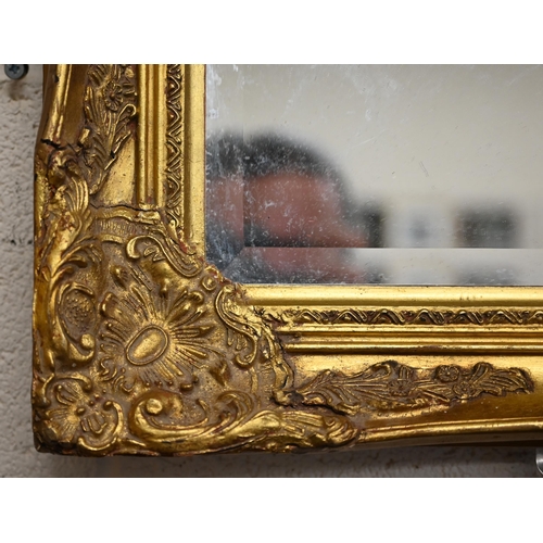 240 - A bevelled rectangular wall mirror in decorative giltwood and gesso frame, 104 x 78 cm a/f