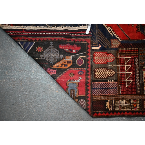 294 - An Afghan pictorial war rug featuring urban street scene, 190 x 120 cm