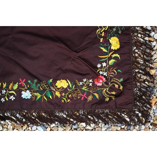 503 - A brown silk triangular piano shawl with colourful longstitched floral border and knotted fringe, 14... 