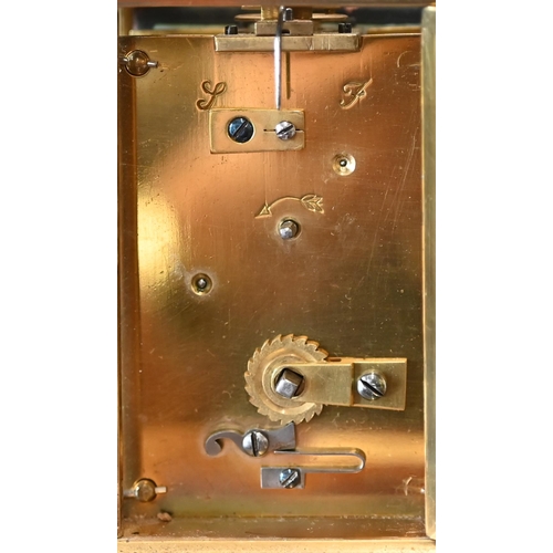 516 - A brass carriage clock, 14cm high overall, in leather case