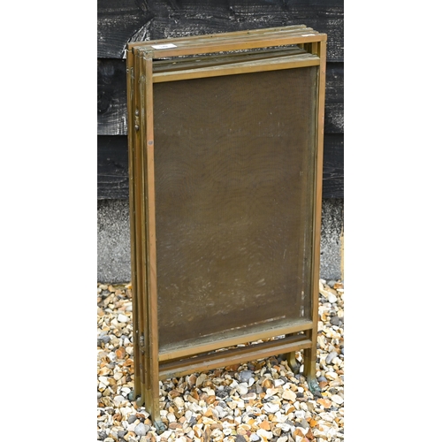 520 - # A four-fold brass fire-screen, 134 cm wide overall to/w copper pots, tray, fire irons and kettle