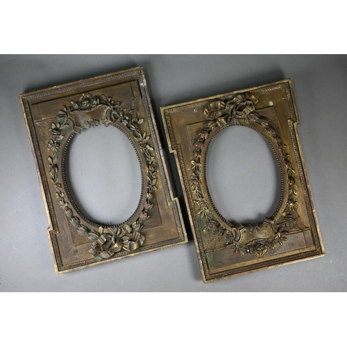 525 - A pair of 19th century gilt gesso frames with oval apertures, floral and ribbon mouldings, 38 x 28 c... 