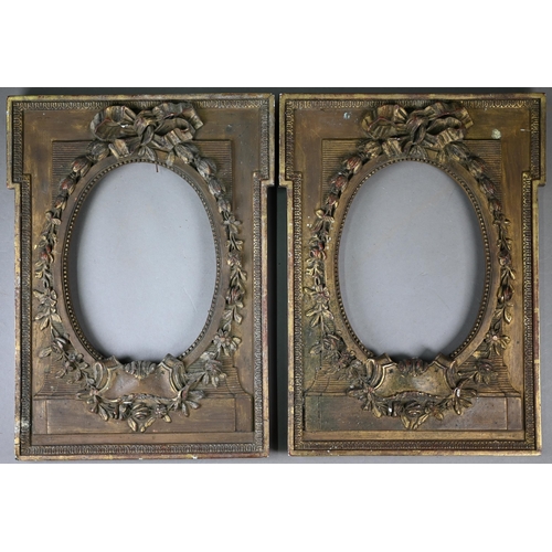 525 - A pair of 19th century gilt gesso frames with oval apertures, floral and ribbon mouldings, 38 x 28 c... 