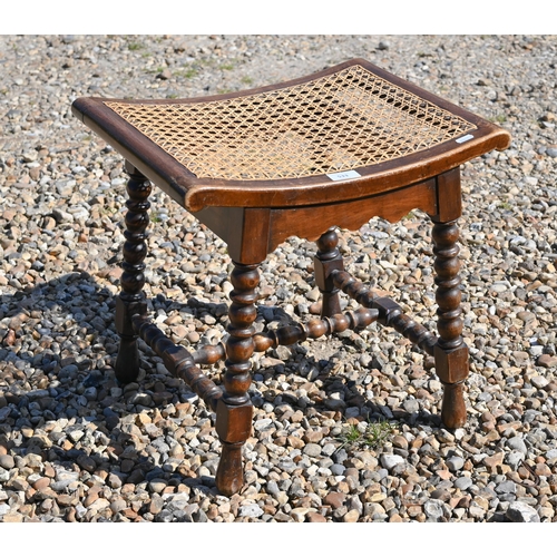 533 - A small oak cane seated stool on bobbin turned supports and stretchers