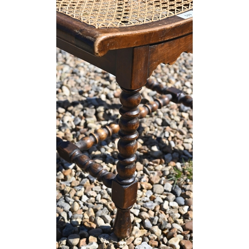 533 - A small oak cane seated stool on bobbin turned supports and stretchers