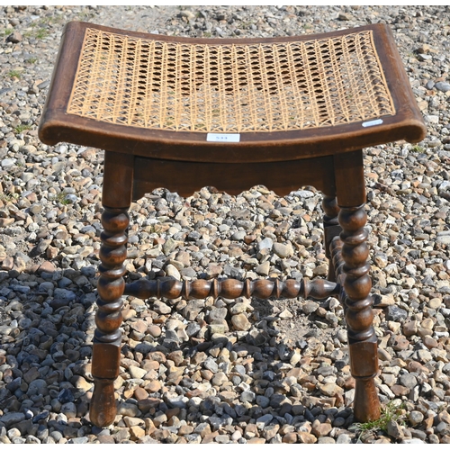 533 - A small oak cane seated stool on bobbin turned supports and stretchers