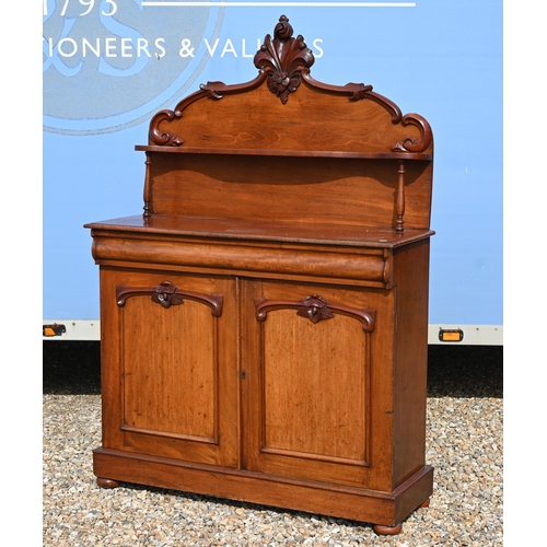 534 - A Victorian carved mahogany chiffonier with raised back over a cushion moulded drawer and panelled c... 