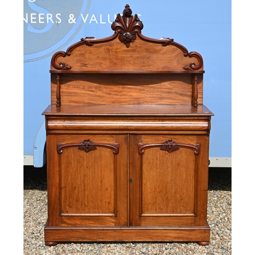 534 - A Victorian carved mahogany chiffonier with raised back over a cushion moulded drawer and panelled c... 