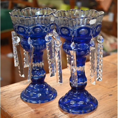 441 - A pair of blue flash glass vases hung with prism lustres, 32 cm high to/w a pair of waisted vases an... 