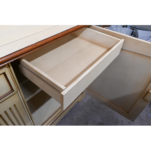 210 - #A French cream painted sideboard by Le Creuset, the two panelled cupboard doors separated by fluted... 