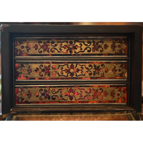 517 - A 19th century continental contre-boulle ebonized and inlaid table cabinet with fall-front enclosing... 