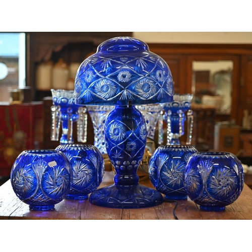 442 - A blue flash glass table lamp with bowl shade, 50 cm high to/w a set of four similar globular bowls ... 