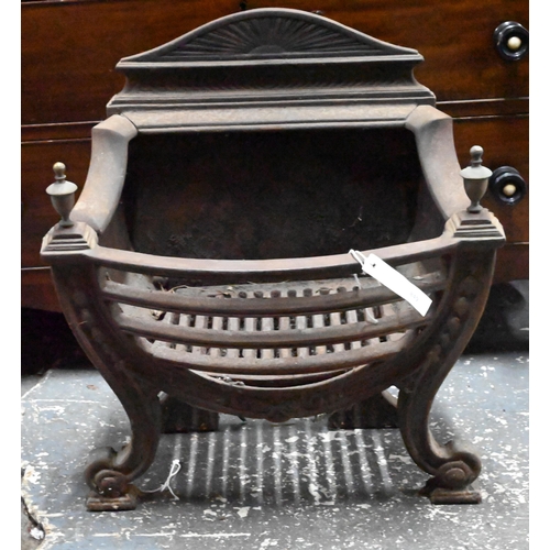 884 - An antique cast iron and brass urn finial Adam style fire basket, with bow front raised on scroll fr... 