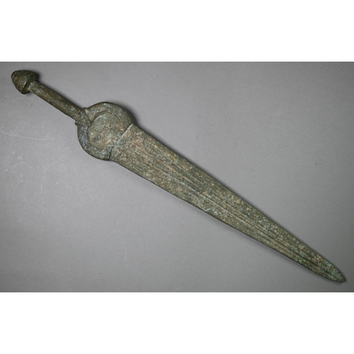 1004 - A Bronze Age sword, the tapering fullered blade with midrib, extending from oval shoulder, with colu... 