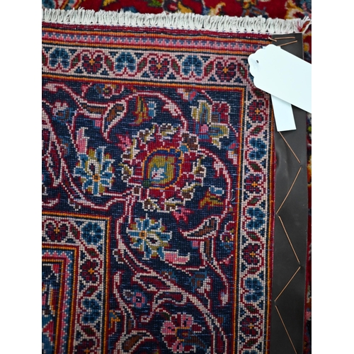 731 - An old central Persian Kashan rug, the wine-red ground centred by a blue ground floral medallion, 21... 