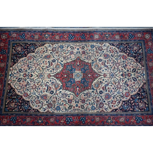 735 - An old North West Persian Sarouk rug, the camel ground with floral garden design, 217 cm x 133 cm