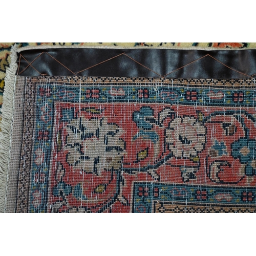 735 - An old North West Persian Sarouk rug, the camel ground with floral garden design, 217 cm x 133 cm