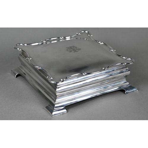 127 - An Edwardian silver jewellery box of ogee form, with hinged lid to gilt and velvet interior, on brac... 