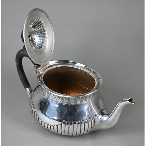 128 - A Victorian silver bachelor teapot of oval squat baluster form with foliate-engraved rim and shallow... 