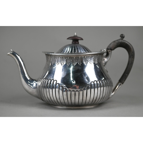 128 - A Victorian silver bachelor teapot of oval squat baluster form with foliate-engraved rim and shallow... 