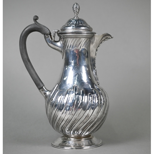 129 - A Victorian silver pear-shaped chocolate pot with spiral finial, ebonised handle and fluted and reed... 