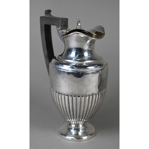 130 - A late Victorian silver urn-shaped hot water jug with hinged lid, half-reeded body and flattened foo... 