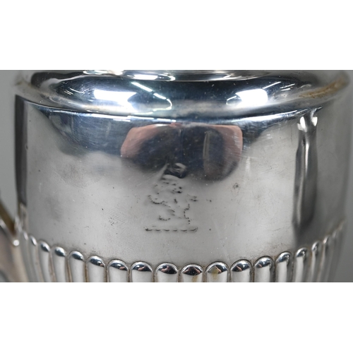 130 - A late Victorian silver urn-shaped hot water jug with hinged lid, half-reeded body and flattened foo... 