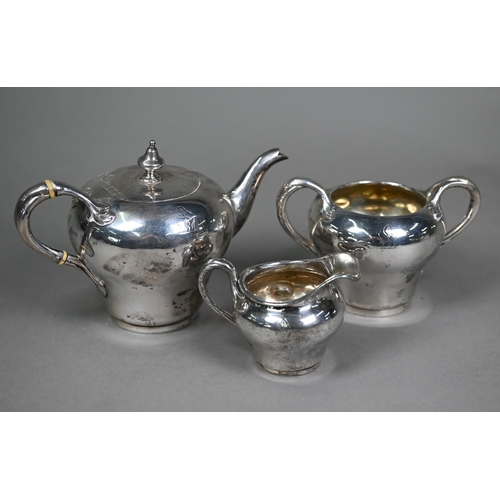 142 - A Victorian silver three-piece bachelor tea service of inverted pear-shape the organic scroll handle... 