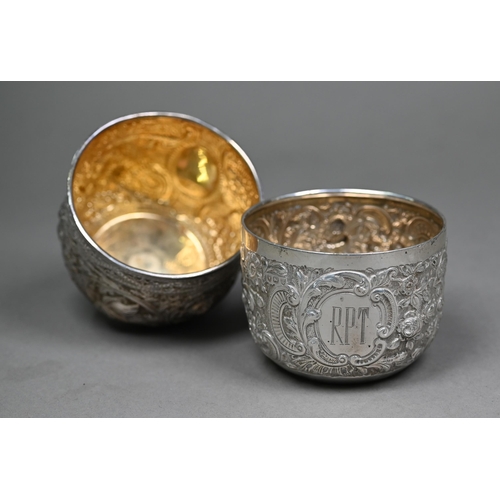 145 - Two late Victorian silver sugar basins, richly embossed and chased in the Indian taste, - both Londo... 