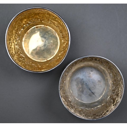 145 - Two late Victorian silver sugar basins, richly embossed and chased in the Indian taste, - both Londo... 