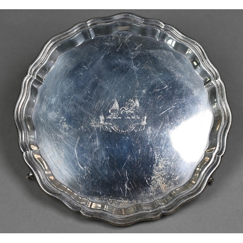 154 - A silver letter salver in the Georgian manner, with moulded rim and three scroll feet, engraved with... 