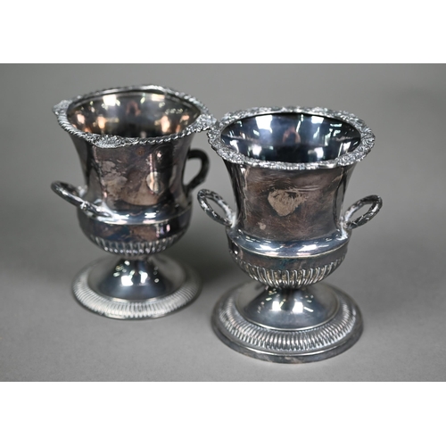 155 - Two late Victorian small silver urns of somewhat similar design with engraved rims and twin handles,... 