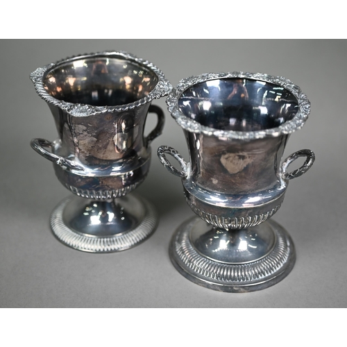 155 - Two late Victorian small silver urns of somewhat similar design with engraved rims and twin handles,... 