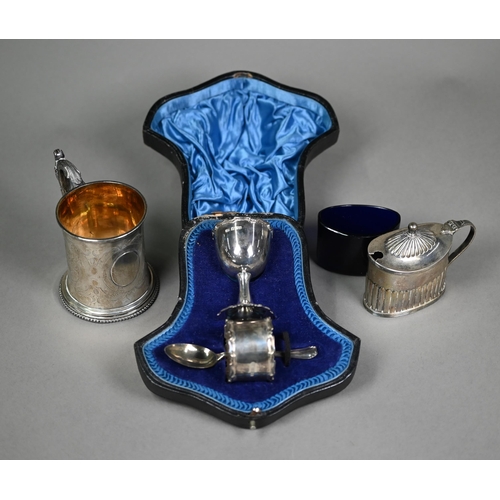 157 - A Victorian engraved silver Christening mug with scroll handle, London 1859, to/w a cased three-piec... 