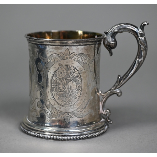 157 - A Victorian engraved silver Christening mug with scroll handle, London 1859, to/w a cased three-piec... 