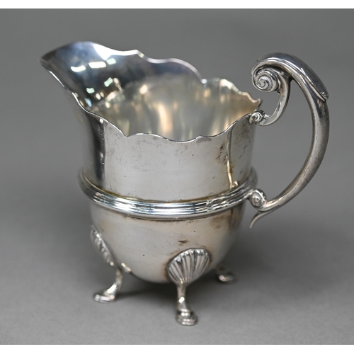 162 - A late Victorian silver helmet-shaped cream jug in the Georgian manner, with scroll handle and hoof ... 