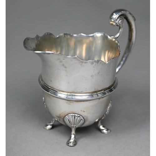 162 - A late Victorian silver helmet-shaped cream jug in the Georgian manner, with scroll handle and hoof ... 