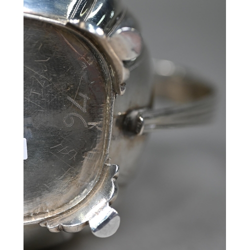 163 - A Regency silver milk jug with egg and dart rim, scroll handle and reeded and engraved decoration, o... 