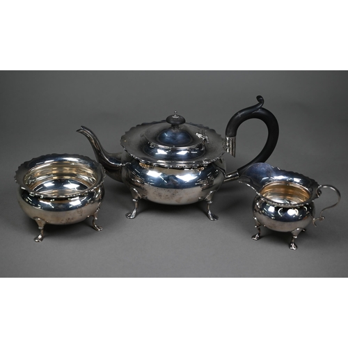 175 - A heavy quality silver three-piece tea service of compressed melon form with shaped rims, pad feet a... 