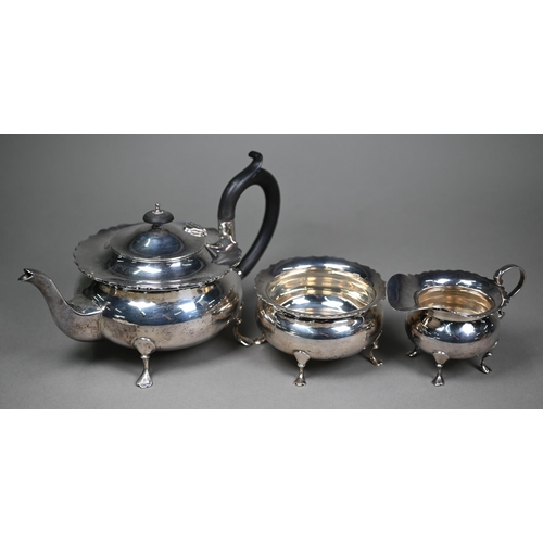 175 - A heavy quality silver three-piece tea service of compressed melon form with shaped rims, pad feet a... 